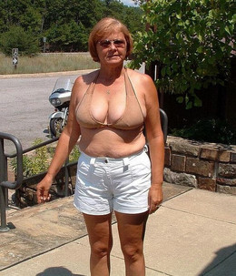 Dissolute granny sunbathing naked on..